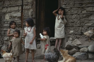 COLUMBIA, Kogi , Young Kogi Indian children standing together at a doorway to a building with