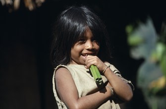 COLUMBIA, Kogi , Portrait of young Kogi Indian child chewing green canes