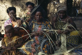 KENYA, Arts, Basket Making, Somali women making basket from woven fibres in Dadaab refugee camp.