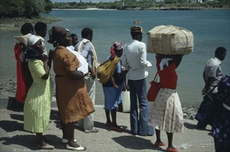 KENYA, Mombasa, Group of men and women waiting for ferry.