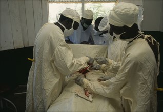 SUDAN, Bahr al Ghazal, Medical team performing hernia operation.