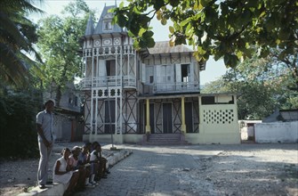 HAITI, Achitecture, Typical domestic architecture.  Colonial style home with children sitting