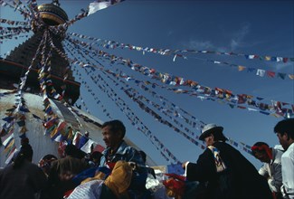 NEPAL, Kathmandu, Bodhanth Stupa, Tibetans hanging the stupa with prayer flags for new year