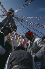 NEPAL, Kathmandu, Bodhanth Stupa, Tibetans hanging stupa with prayer flags during new year
