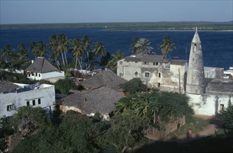KENYA, Lamu Island, Town rooftops and sea beyond.