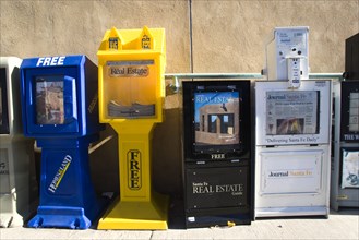 USA, New Mexico, Santa Fe, Newspaper and real estate vending machines on the pavement