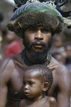 PAPUA NEW GUINEA, New Guinea, "Melpa tribesman wearing hat decorated with fur, feathers and leaves