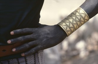 SUDAN, Tribal People, Cropped shot of Dinka man wearing brass bracelet decorated with abstract