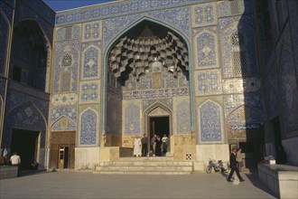 IRAN, Esfahan, People standing at entrance to Lotfallah Mosque in Mediun E eman Square