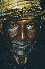 CUBA, Work, Head and shoulders portrait of miner covered with sweat and coal dust.