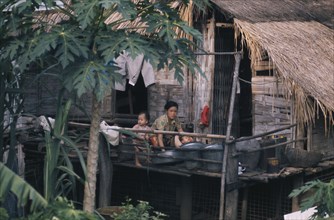 LAOS, People, Family, Mother bathing children outside stilt house