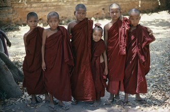 MYANMAR, Mandalay, Line of Novice Monks in red robes