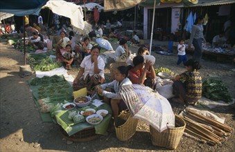 LAOS, Vang Vieng, Vendors behind fruit and vegetable stalls