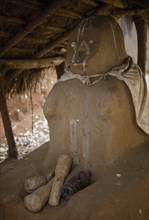 GHANA, Volta Region, Fetish figure at shrine entrance in black magic temple.