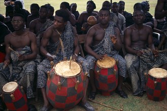 GHANA, Kumasi, Drummers playing at funeral of wife of a chief.
