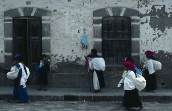 ECUADOR, Imbabura, Cotocachi, Women returning from cemetery after praying for the dead on Easter