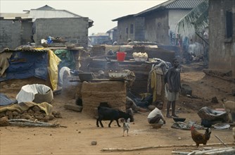 GHANA, Village Scene, "Outside ovens in village near Accra with children, goats and chickens around