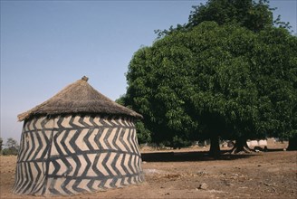 GHANA, Architecture, Traditional mud architecture.  Circular hut or granary with straw roof and