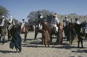 CHAD, People, Kanimbo men on horses holding swords above their heads as a welcoming to the Chiefs