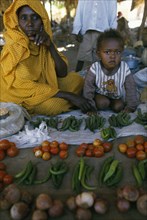 ERITREA, Barentu, Woman and child behind market stall selling fruit and vegetables