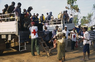 GUINEA , Kissidougou, Camp for Sierra Leonean refugees. People arriving in trucks at new camp