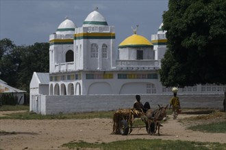 GAMBIA, Religion, Islam, Village Mosque with a boy on a donkey and cart in the foreground
