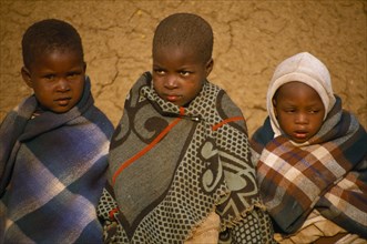 LESOTHO, People, Children, Three children wrapped in blankets