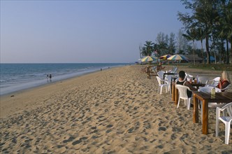THAILAND, Andaman Sea, Takua Pa district, "Khao Lak, A couple sat at a table on the sandy beach,