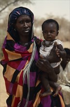 SUDAN, North Kordofan Prov., Tribal People, Portrait of Dar Hamid woman carrying child.  The Dar
