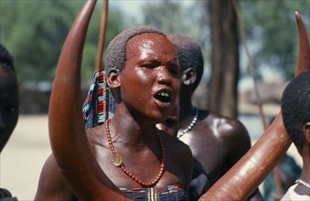 SUDAN, Tribal People, Dinka girl with red painted face at festival celebrating the return of cattle