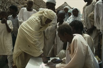 SUDAN, Kordofan Province, Umm Eshera, Signing for sorghum received in food distribution organised