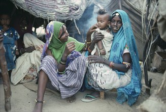 SUDAN, South Tokar, Beni Amer tribeswomen and child refugees in camp settlement.