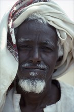 SUDAN, East, Tawawa Settlement, Head and shoulders portrait of Ethiopian refugee man with white