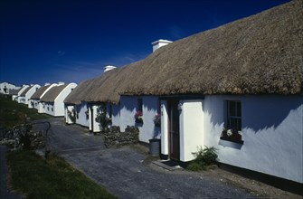 IRELAND, County Galway, Galway, "Row of traditional white painted, thatched cottages."
