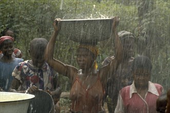 NIGERIA, Imo State, Women during wet season harvesting rainwater as part of UNICEF water project.