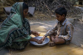 BANGLADESH, Children, Young boy learning the importance of washing hands.