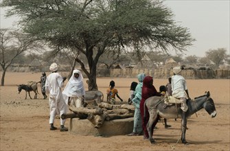 SUDAN, Kordofan, North, People using donkey to help draw water from well.
