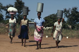 MOZAMBIQUE, Water, Group of women carrying water vessels on their heads.