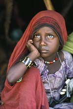SUDAN, North East, Gadem Gafriet Camp, Portrait of Beni Amer Beja nomad refugee girl with chin