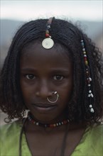 SUDAN, North East, Gadem Gafriet Camp, Portrait of Beni Amer Eritrean refugee girl wearing
