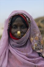 SUDAN, North East, Gadem Gafriet Camp, Head and shoulders portrait of Beni Amer nomad refugee woman