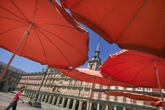 SPAIN, Madrid, "Red restaurant parasols in Plaza Mayor, Main Square."