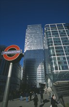 ENGLAND, London, Canary Wharf. The tower at 1 Canada Square with Underground station sign in the