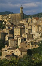 ITALY, Tuscany, Sorano, Etruscan town.  View over stone houses with tiled rooftops and clock tower
