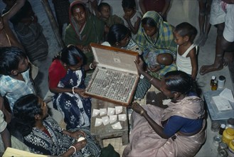 INDIA, West Bengal, "Woman doctor dispensing traditional Ayurvedic medicines at clinic.  Herbal