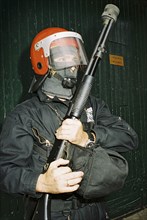 SPAIN, Hondarabia, The Basque Country, Basque riot policeman holding gun during the festival of El