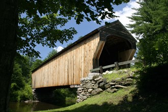USA, New Hampshire, Newport, "Corbin Bridge, wooden covered bridge, going over water."