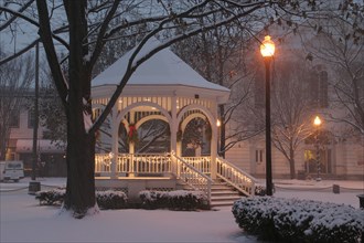 USA, New Hampshire,  Keene Common, "Gazebo or band stand in early morning snowstorm, Christmas