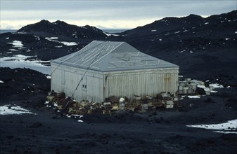 ANTARCTICA, Ross Island, "Shackleton’s Hut at Cape Royds,  with crates stacked around the sides of