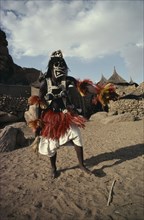 MALI, Ceremony, "Portrait of Dogon dancer wearing costume of short fringed red and yellow skirt,